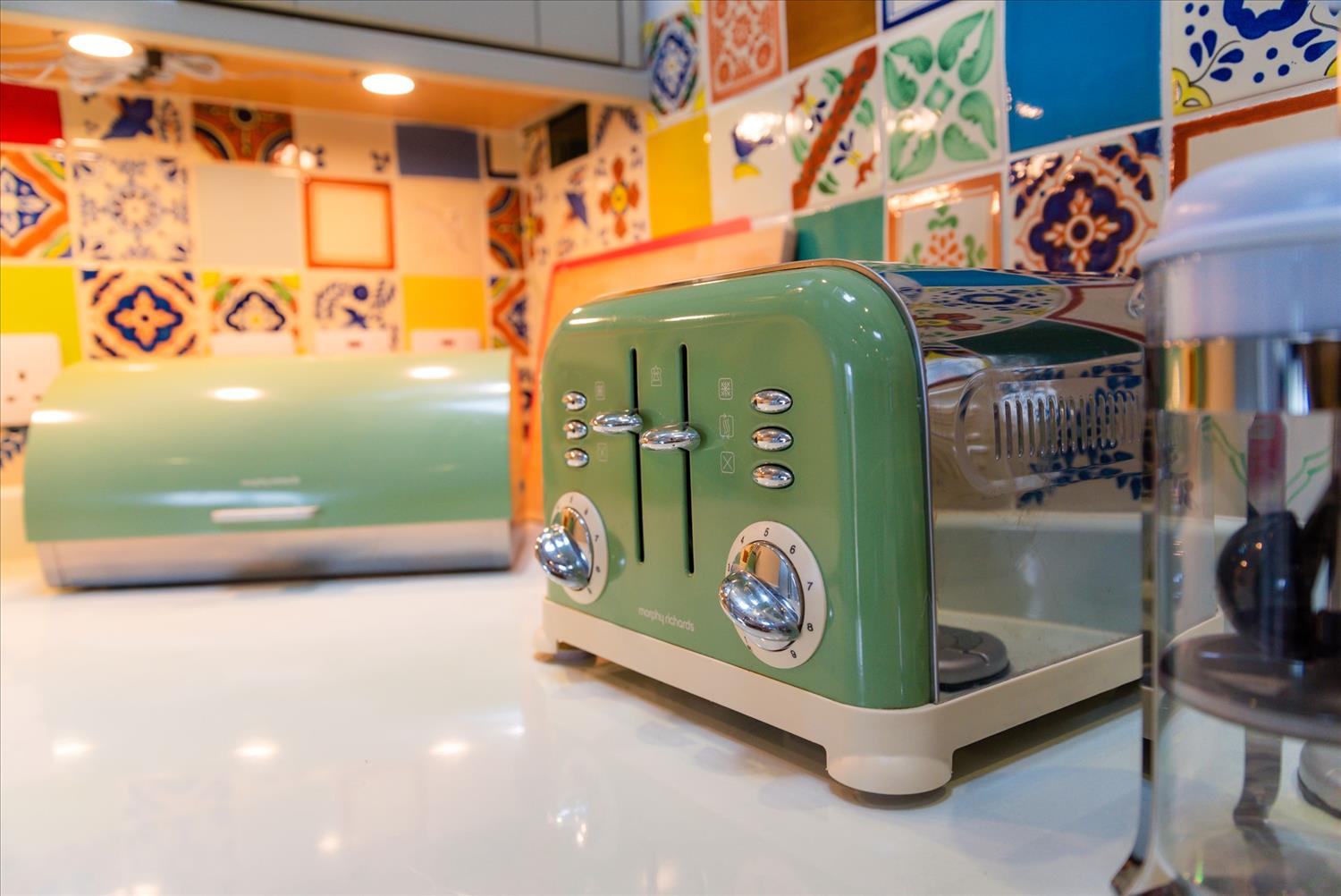 Close-up of Sloe Cottage's retro-style royal green toaster and breadbin